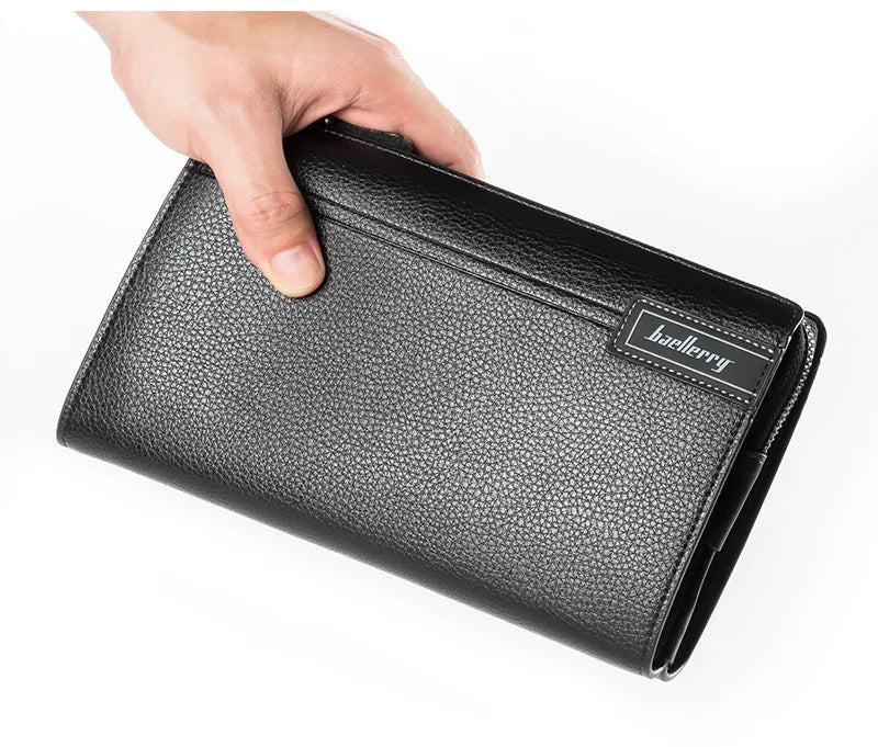 A hand is holding a black leather business card clip wallet.