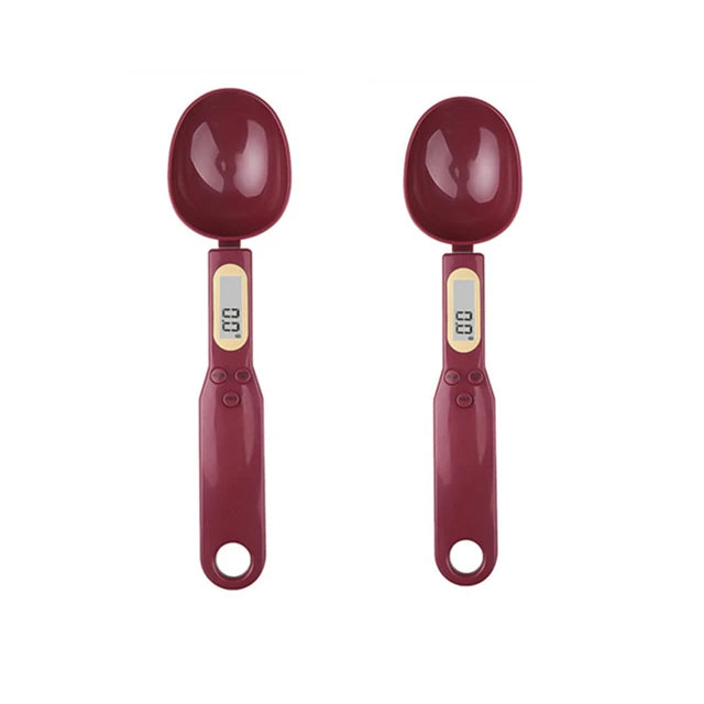 A pair of maroon precision digital kitchen scales with measuring spoons and a digital display.