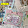 A pink and light blue transparent shoulder tote bag decorated with fluffy white animals and pearl accents.