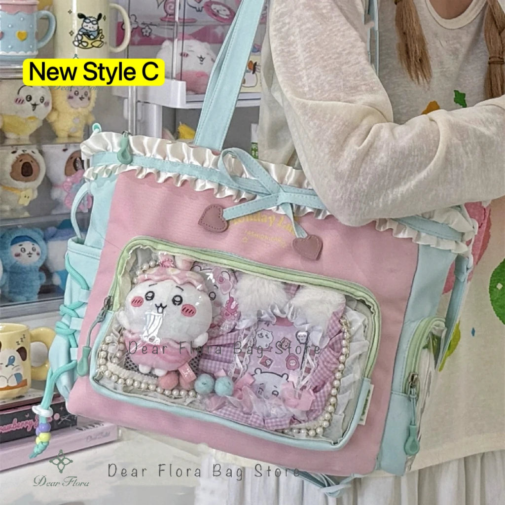 A pink and light blue transparent shoulder tote bag decorated with fluffy white animals and pearl accents.