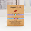 A set of three beaded friendship bracelets with 'I love you' messages presented in a card.