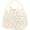 A pale pink and white corduroy lunch bag with a rounded top and fabric handles.