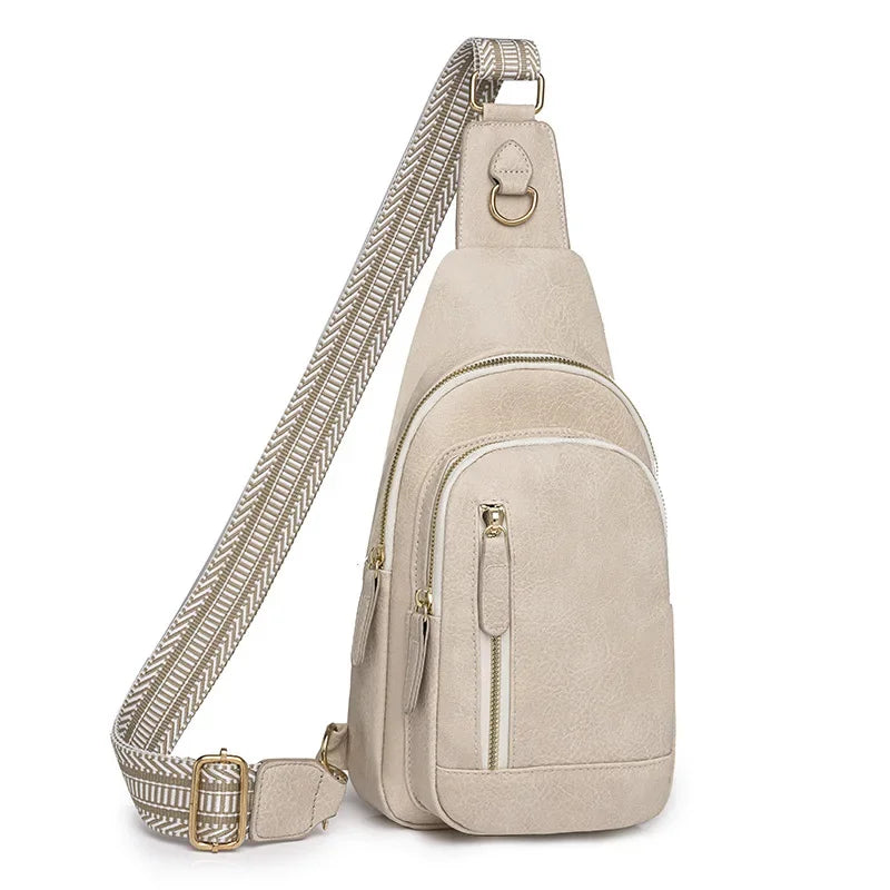 A beige PU leather crossbody sling bag with a patterned strap and gold hardware.
