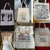 A canvas tote bag featuring an alphabet floral print with text like I SIN GRAPE JUICE and Gracias por enseñarnos con el coraz
