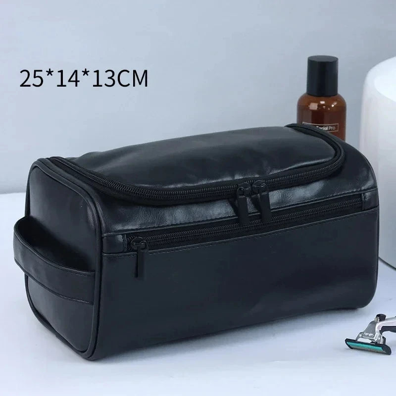 A black leather toiletry bag with a zipper is shown on a white surface.