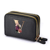 Black mini wallet with gold zipper featuring a floral letter print design