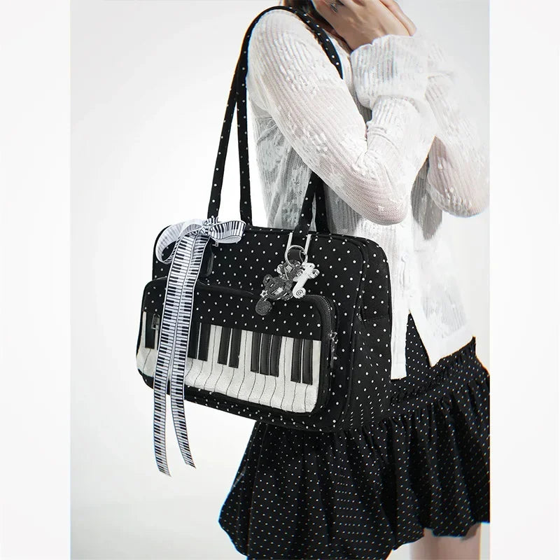 A woman holds a black and white piano print crossbody bag with a strap featuring musical note embroidery.