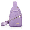 Sac bandoulière à motif matelassé violet avec fermeture éclair et sangle sur fond blanc.