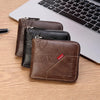 A stack of brown and black men's PU waxed oil leather bifold wallets resting on a wooden surface next to a laptop.