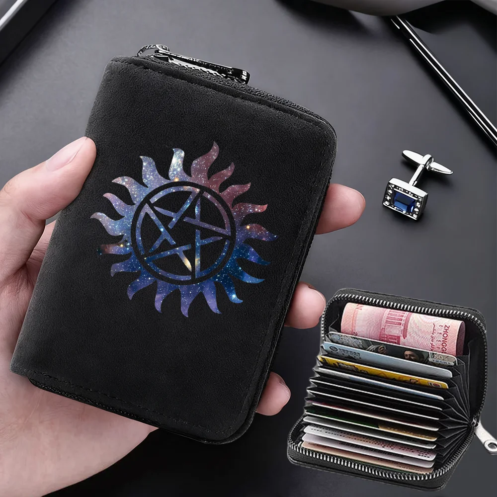 A black compact RFID-blocking card wallet with a solar symbol design is held in a hand next to a separate zippered card holde