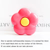 A bright pink flower shaped phone grip ring stand with small black dots on the surface.
