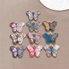 A set of colorful butterfly enamel charms featuring various floral and patterned designs.
