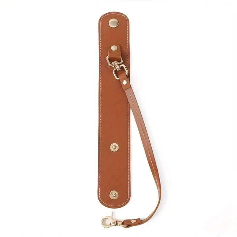 A brown vintage leather glove holder strap with a metal clasp and multiple rivets.