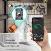 A hand holds a smartphone displaying a location alert for a lost wallet, next to a slim metal card holder.