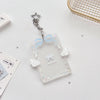 Clear acrylic photocard holder with a silver charm and a light blue ribbon bow