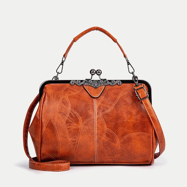 A brown leather crossbody shoulder bag with a decorative metal clasp and leather strap.