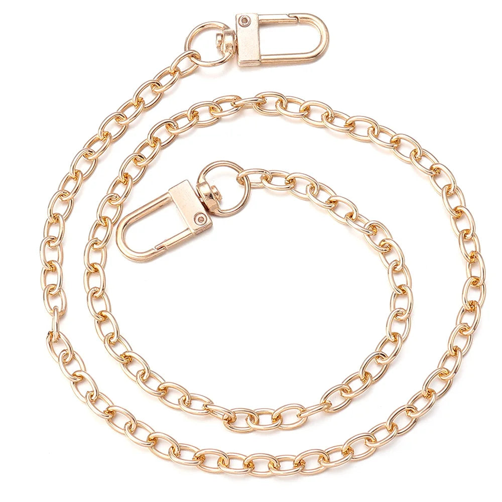 Gold-toned adjustable metal bag strap chains displayed on a white background.
