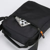 Black men's crossbody sling bag featuring a zippered pocket with multiple interchangeable lenses.
