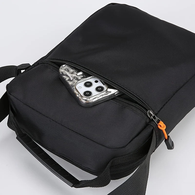 Black men's crossbody sling bag featuring a zippered pocket with multiple interchangeable lenses.