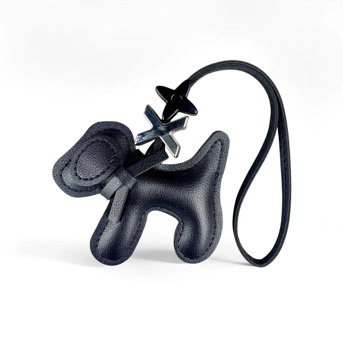 Black PU leather puppy bag charm featuring a bow tie detail on a black leather strap.