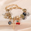 A gold and leopard print beaded bracelet featuring crosses, stars, and black beads.