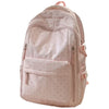 A light pink corduroy backpack with a bow print design and multiple zippered compartments.