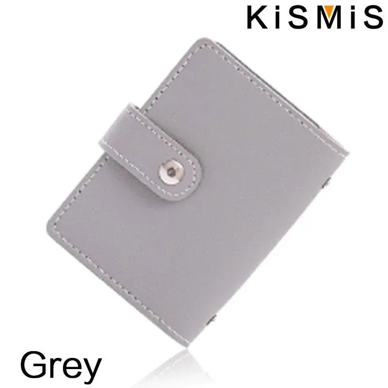 A grey slim leather card holder with a stitched edge and a metal clasp is shown from above.
