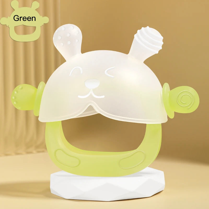 A clear silicone teether shaped like a cute bunny for babies, with a green color, displayed on a white stand.