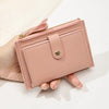 A light pink ultra-thin PU leather card holder wallet with a gold zipper and silver-toned clasp being held by a hand.