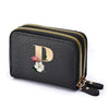 Black faux leather mini wallet with a gold letter print and double zipper closure