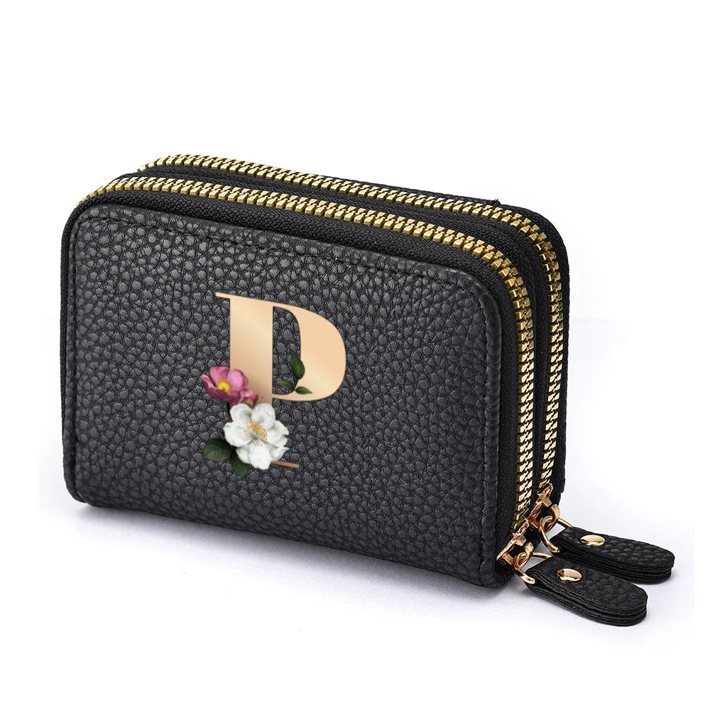 Black faux leather mini wallet with a gold letter print and double zipper closure