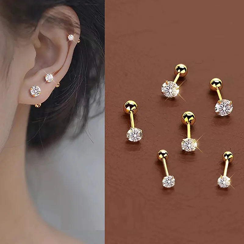 A set of gold-toned stainless steel stud earrings featuring various diamond and clear stones.