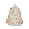 A light beige corduroy fashion backpack with a floral pattern and a yellow charm.