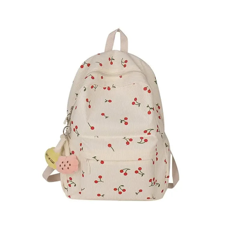 A light beige corduroy fashion backpack with a floral pattern and a yellow charm.