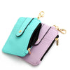 A teal silicone PU leather key chain wristlet wallet with a purple version displayed against a white background.