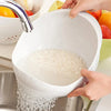 A hand is pouring grated coconut into a white plastic drain and storage basket.