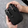 A hand holds a black portable multi-tool organizer pouch with a mesh insert for outdoor gear.