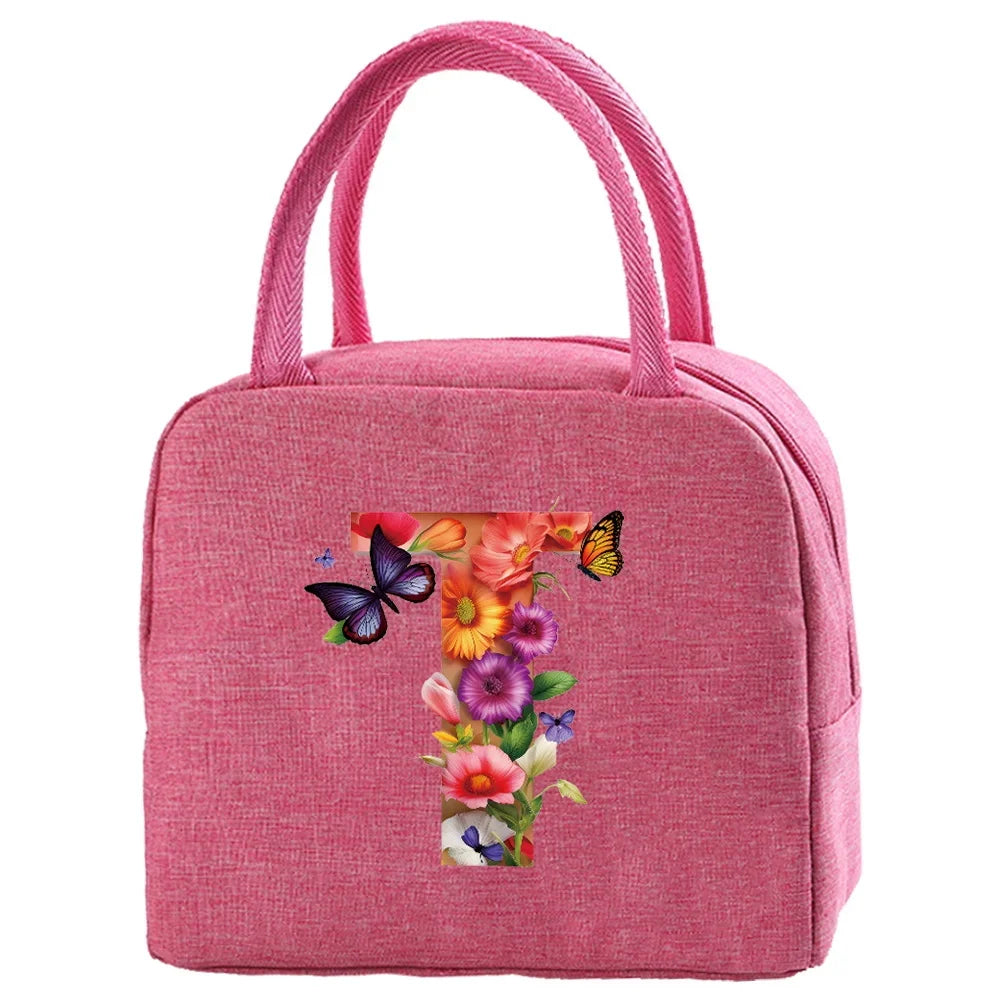 A pink insulated canvas lunch bag featuring a floral butterfly design.