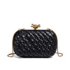 A black handwoven clutch evening bag with a gold-toned clasp and chain detail.