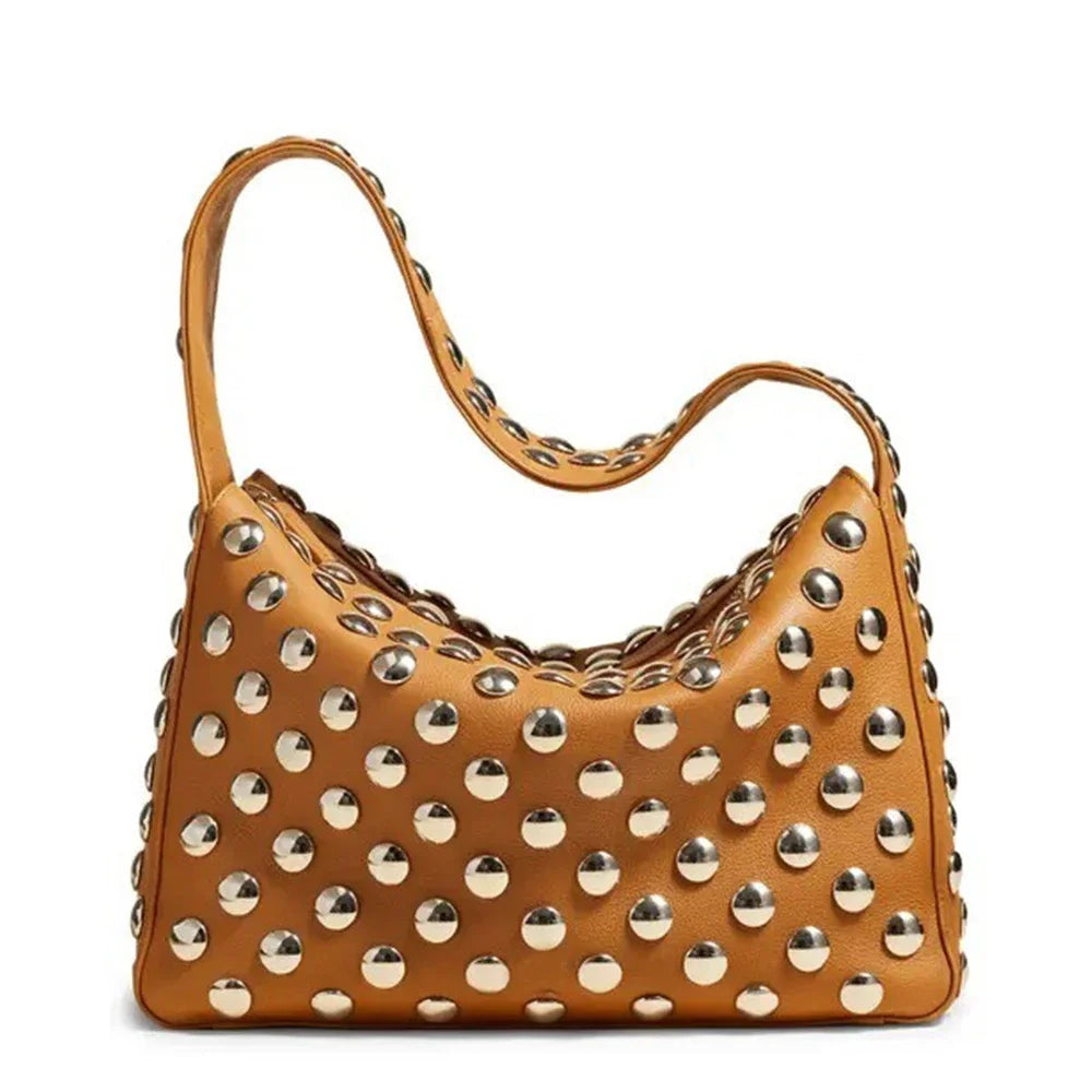 A tan designer metal rivet shoulder bag with a textured surface and gold-toned hardware.