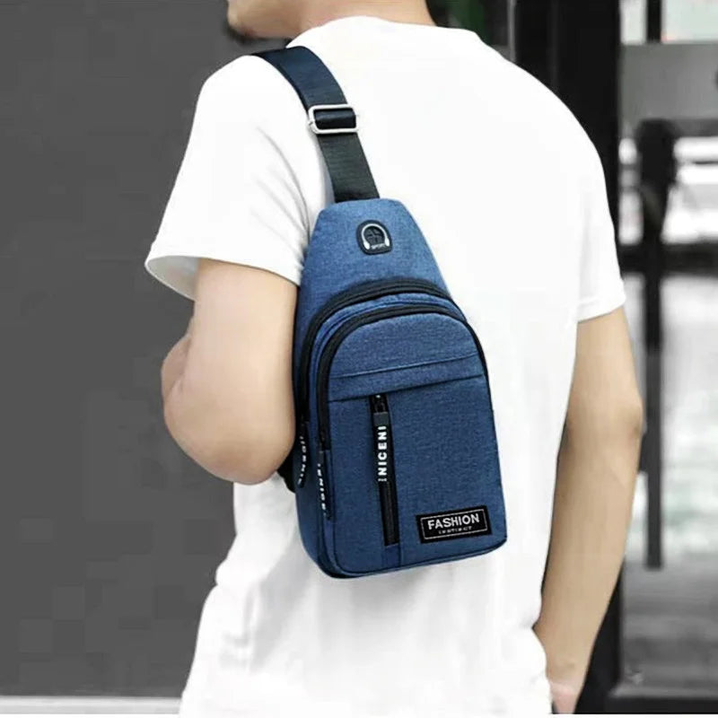 A person is wearing a navy blue casual chest bag with a phone pocket on their white t-shirt.