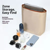 A beige satin bag organizer insert with multiple compartments holds a smartphone, sunglasses, and other small items.
