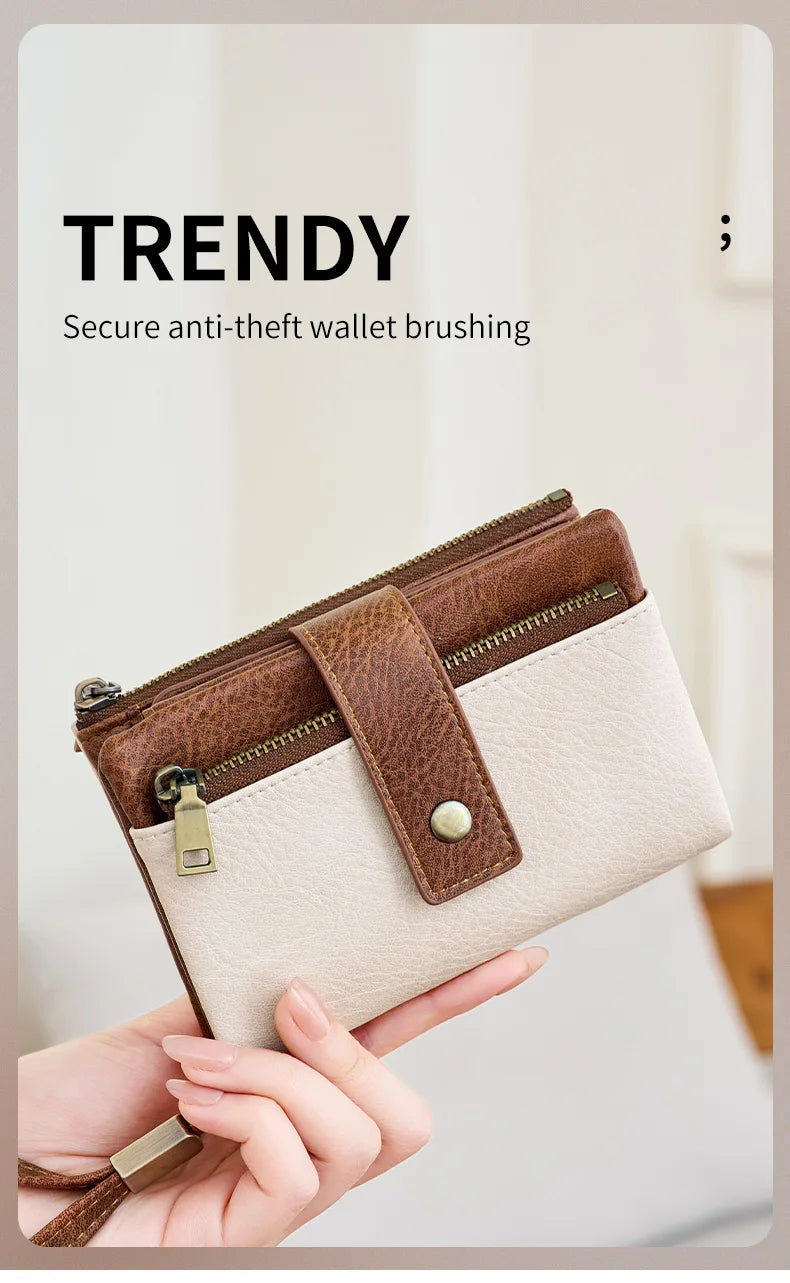 A close-up of a brown leather wallet with brass hardware and a beige lining, being held by a hand.