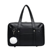 Black leather preppy shoulder bag with a white pom-pom detail