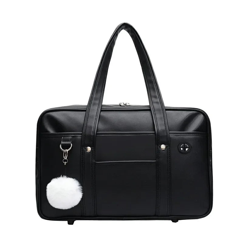 Black leather preppy shoulder bag with a white pom-pom detail