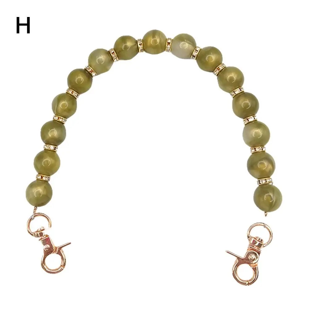 Handcrafted resin stone bead bag chain with light green beads and gold-toned clasps
