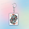 A silver keychain featuring a square charm with pixel art of Deltarune chibi poker cards.