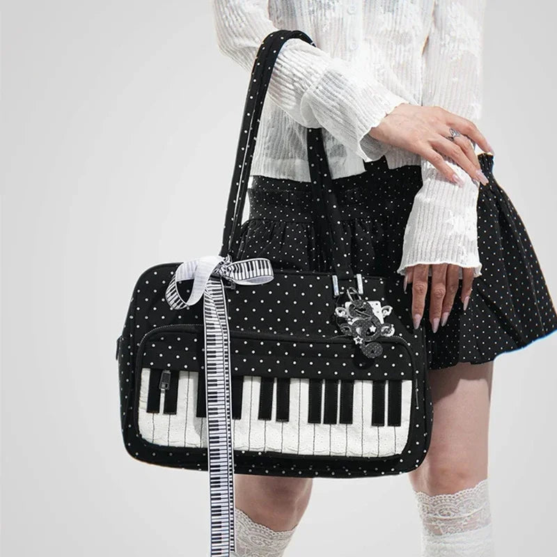 A woman holds a black and white piano print crossbody bag with musical note embroidery.