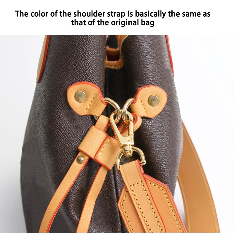 Close-up of a dark brown bag showing an adjustable tan leather shoulder strap detail.