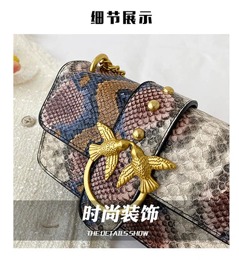 A close-up of an elegant retro crocodile print crossbody bag featuring gold hardware and a bird charm.